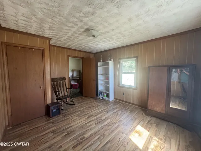 a view of a room with wooden floor and furniture