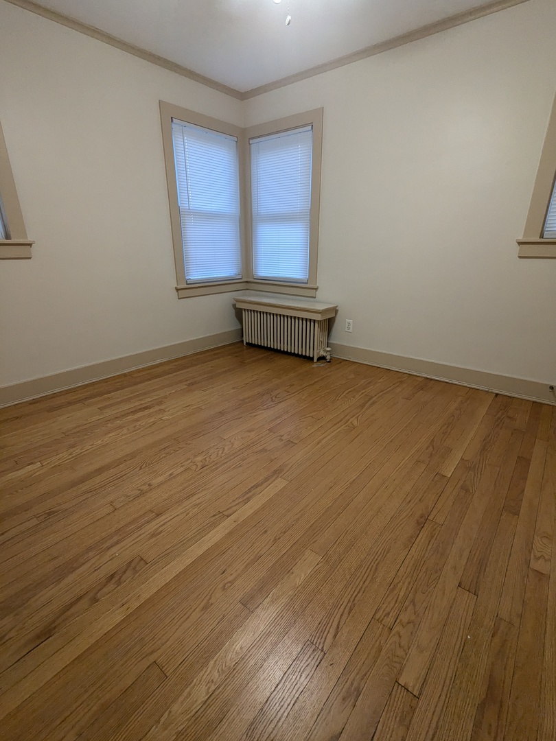 328 West St Charles Road, Unit B2 Lombard, IL 60148 - Photo 11 of 26 an empty room with wooden floor and windows