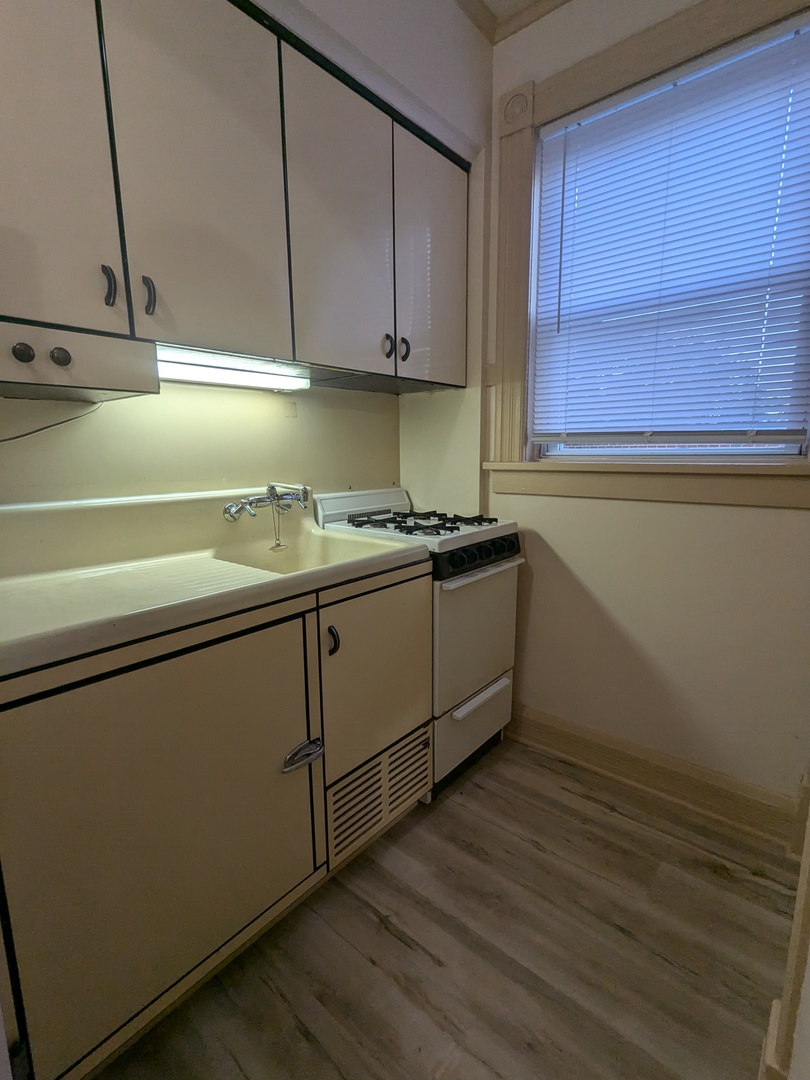 328 West St Charles Road, Unit B2 Lombard, IL 60148 - Photo 23 of 26 a kitchen with a sink and cabinets