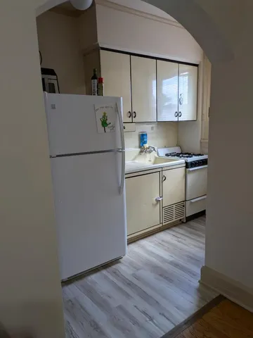 a kitchen with appliances a sink and a cabinets