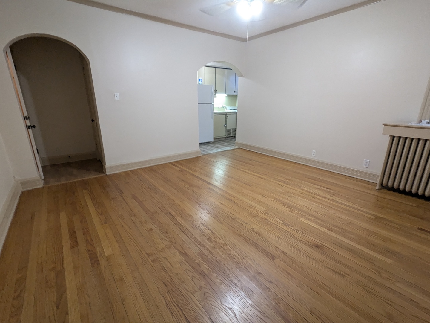 328 West St Charles Road, Unit B2 Lombard, IL 60148 - Photo 10 of 26 a view of empty room with wooden floor and fan