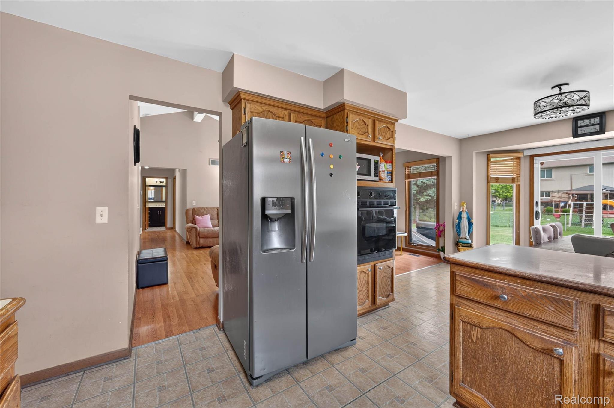 46362 Springhill Drive Utica, MI 48317 - Photo 16 of 59 Kitchen featuring an integrated stainless steel refrigerator, built-in double ovens, and tile flooring