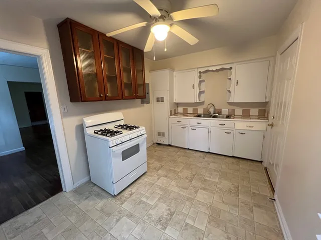 a kitchen with stainless steel appliances a stove a sink and a refrigerator