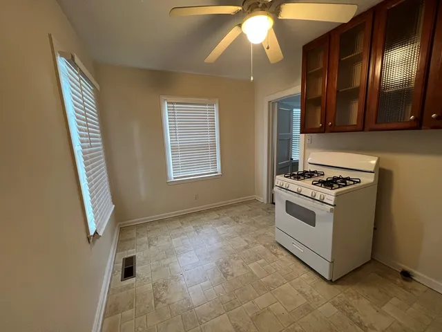 a view of a yard with a house and large trees