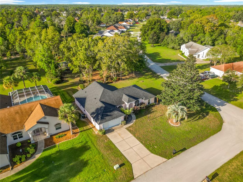 an aerial view of a house with swimming pool and ocean view