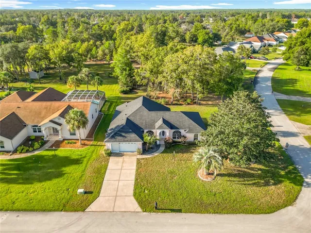 an aerial view of a house with swimming pool and ocean view