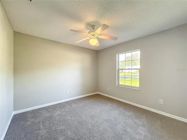 a view of a livingroom with a ceiling fan and window