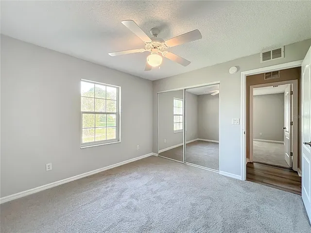 a view of a livingroom with a ceiling fan and window