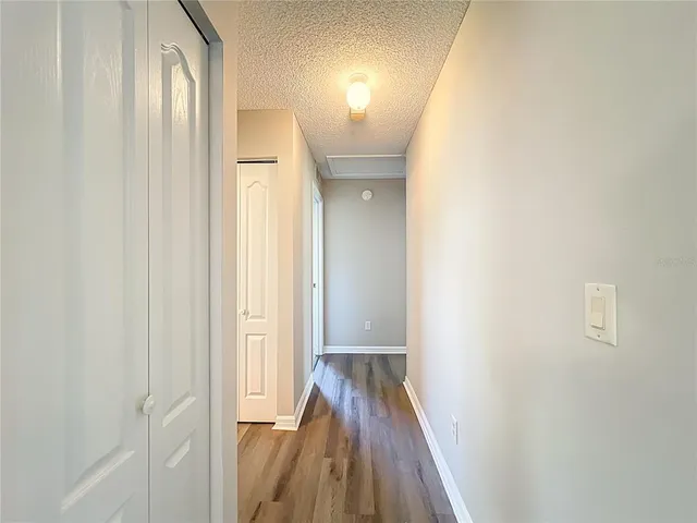 an aerial view of residential houses with outdoor space and trees all around
