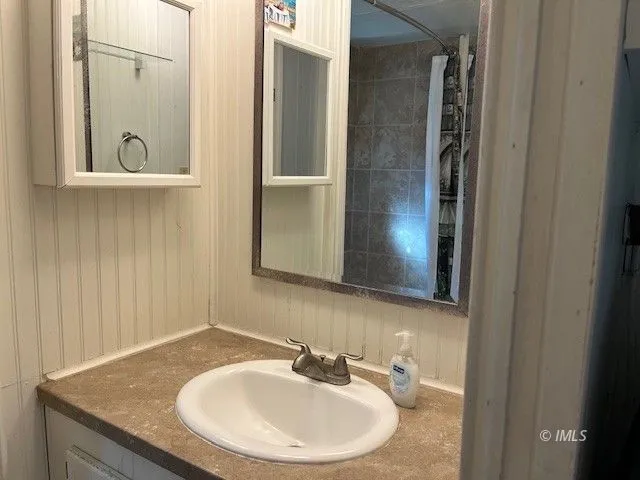 a bathroom with a sink and a mirror