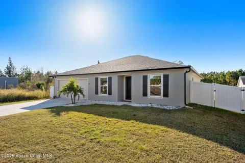 a living room with furniture and a ceiling fan