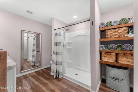 a bathroom with a shower and a sink
