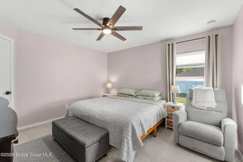 a bedroom with a bed couch and window