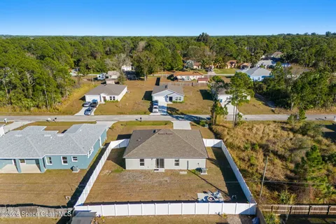 an aerial view of residential houses with outdoor space
