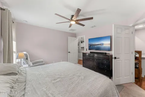 a bedroom with a bed and a flat screen tv