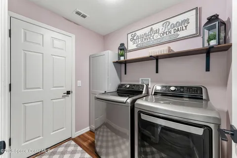 a kitchen with stainless steel appliances a sink stove and wooden floor