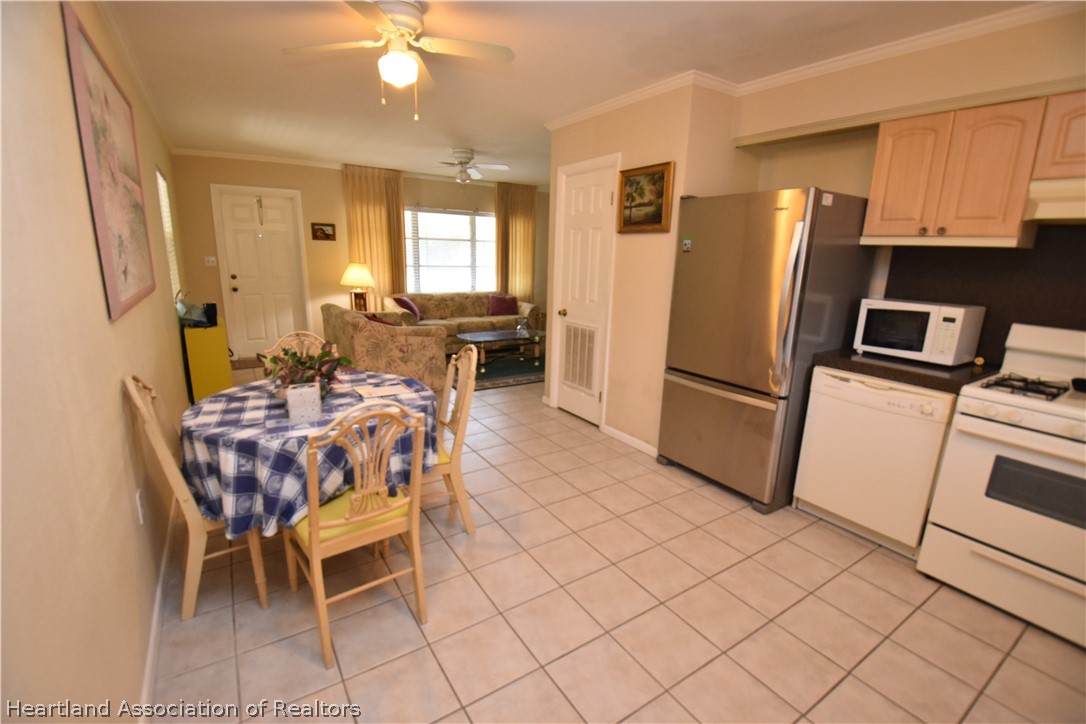 3906 Lakewood Road Sebring, FL 33875 - Photo 5 of 18 a dining room with furniture a sink a refrigerator and a window