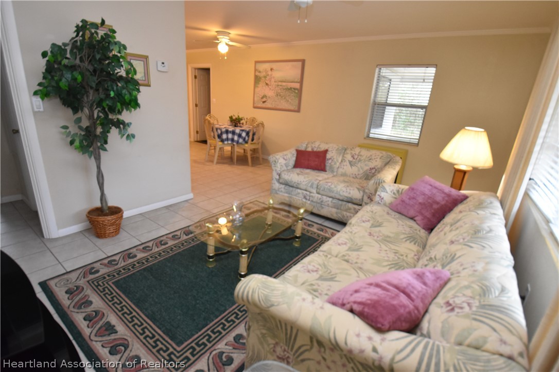 3906 Lakewood Road Sebring, FL 33875 - Photo 7 of 18 a living room with furniture and a potted plant