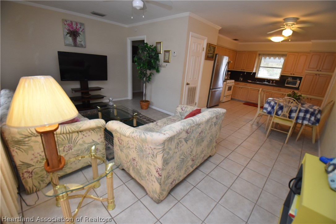 3906 Lakewood Road Sebring, FL 33875 - Photo 8 of 18 a living room with furniture and a flat screen tv