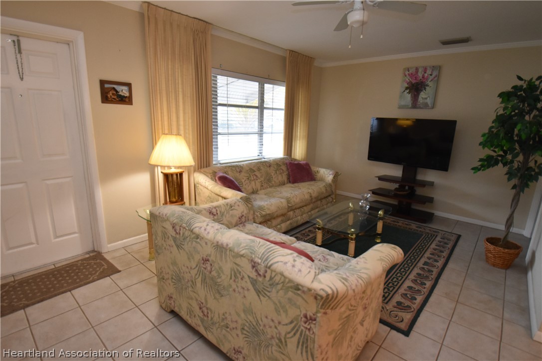 3906 Lakewood Road Sebring, FL 33875 - Photo 9 of 18 a living room with furniture and a window