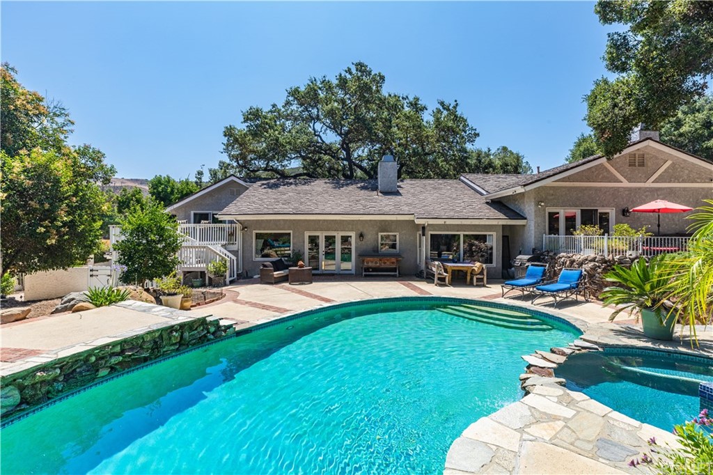 2323 Stokes Canyon Road Calabasas, CA 91302 - Photo 1 of 1 a front view of a house with swimming pool having outdoor seating