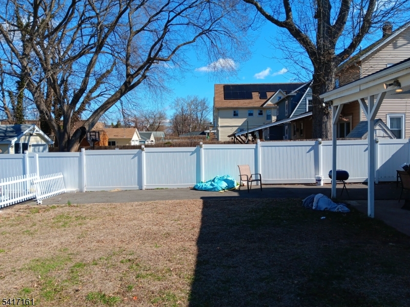 1028 West 5th Street Plainfield, NJ 07063 - Photo 11 of 13 a backyard of a house with table and chairs