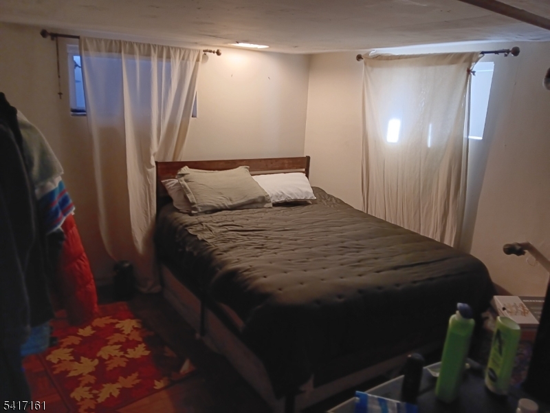 1028 West 5th Street Plainfield, NJ 07063 - Photo 7 of 13 a bed sitting in a bedroom next to a bathroom
