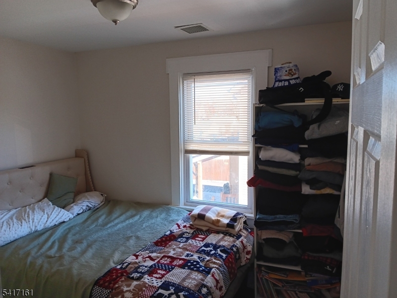 1028 West 5th Street Plainfield, NJ 07063 - Photo 9 of 13 a bedroom with a bed and a window