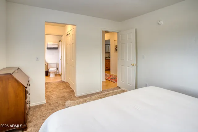 a bedroom with a bed and a lamp on table