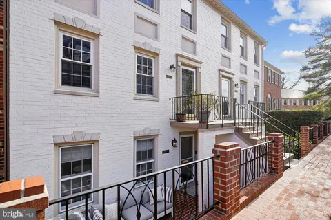 a view of a house with wooden fence