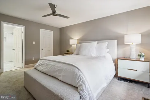 a bedroom with a bed and a lamp