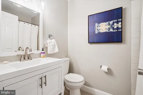 a bathroom with a sink mirror and toilet