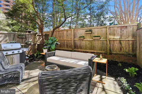 a view of backyard with seating space and trees