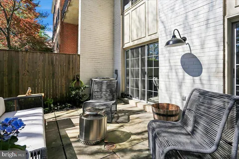 a view of a patio with couches chairs and potted plants