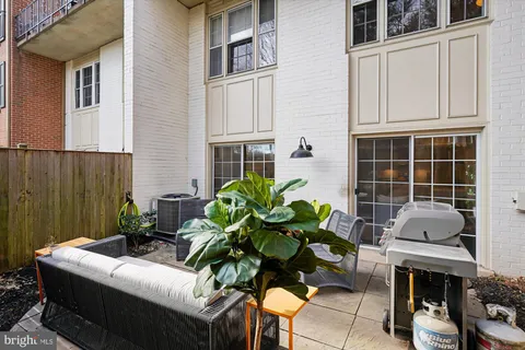 a view of a patio with couches table and chairs and potted plants