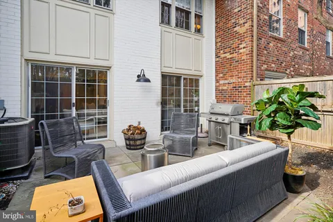 a view of backyard of house with outdoor seating