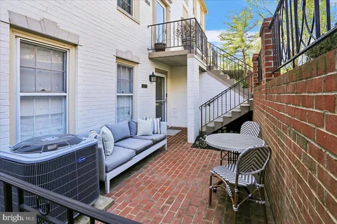 a view of a patio with two couches and table with wooden floor