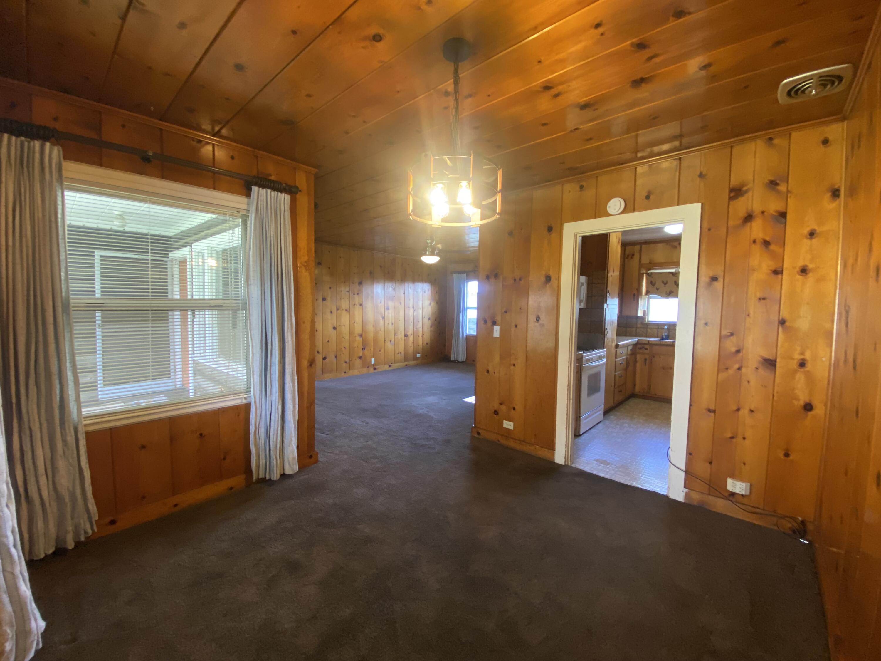 230 Myrtle Street Chester, CA 96020 - Photo 14 of 46 a view of a hallway with wooden floor and a bathroom