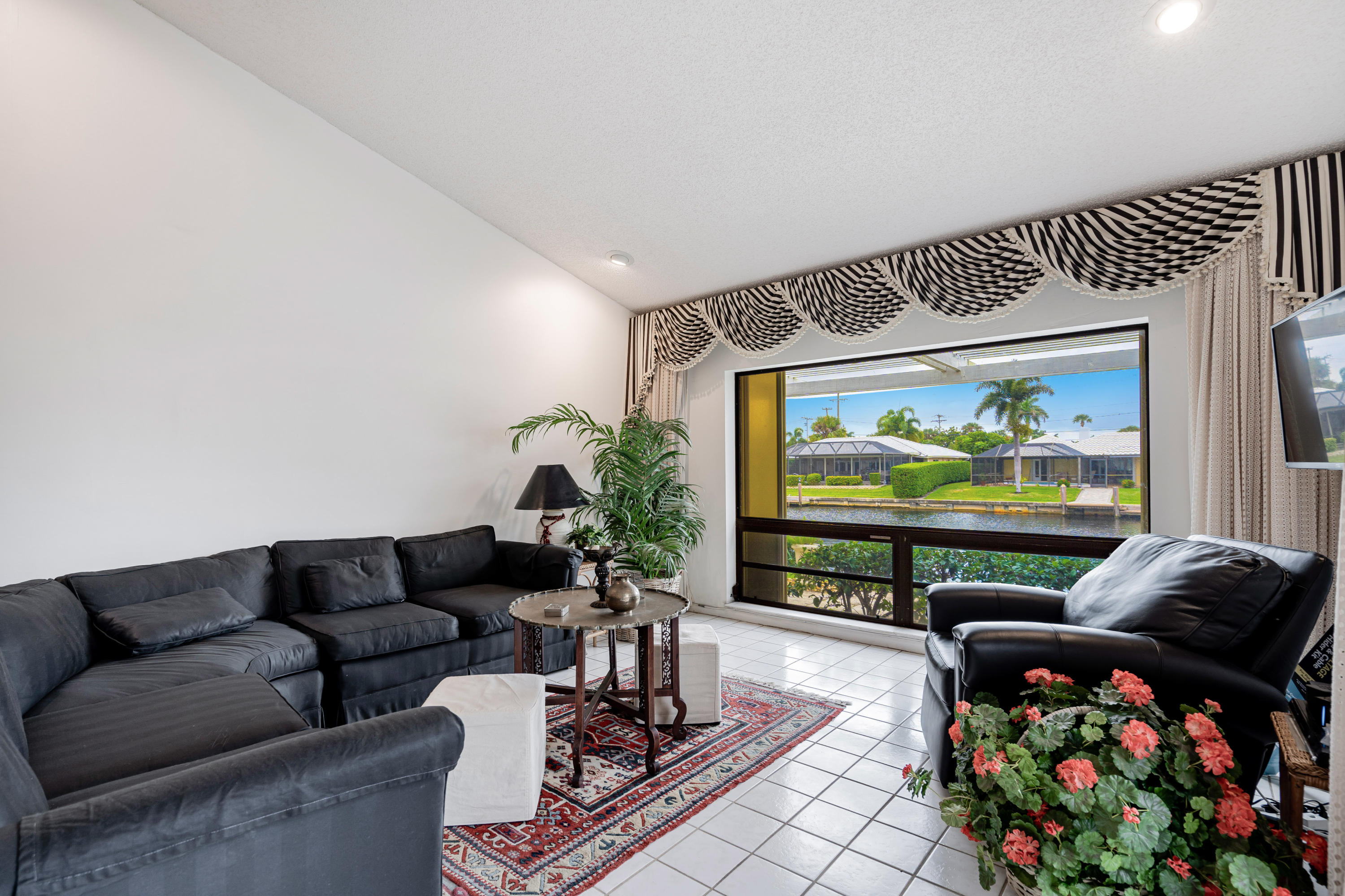 861 Camino Gardens Lane Boca Raton, FL 33432 - Photo 11 of 37 a living room with furniture and a flat screen tv