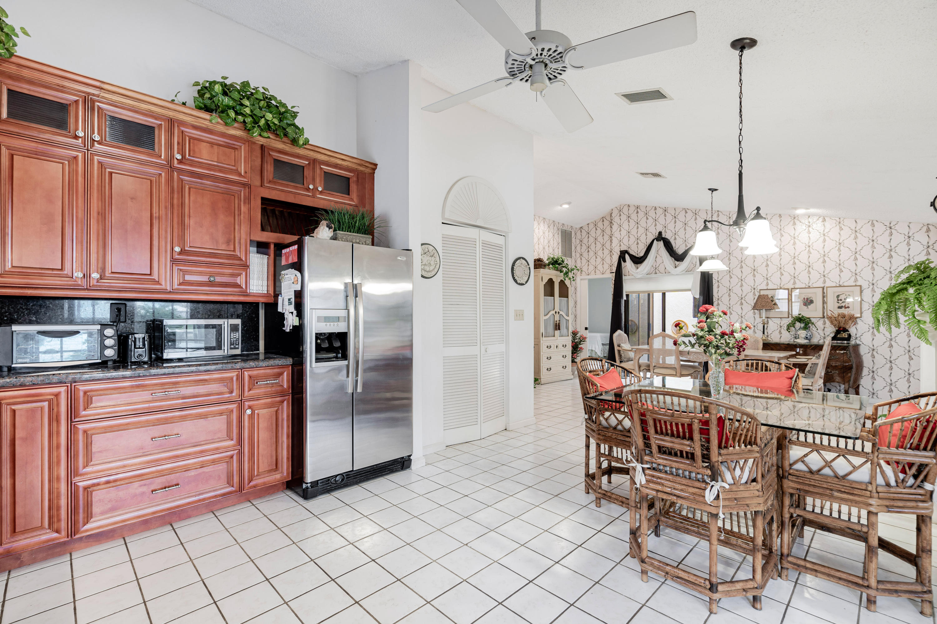 861 Camino Gardens Lane Boca Raton, FL 33432 - Photo 16 of 37 a kitchen with stainless steel appliances granite countertop a refrigerator and a stove top oven