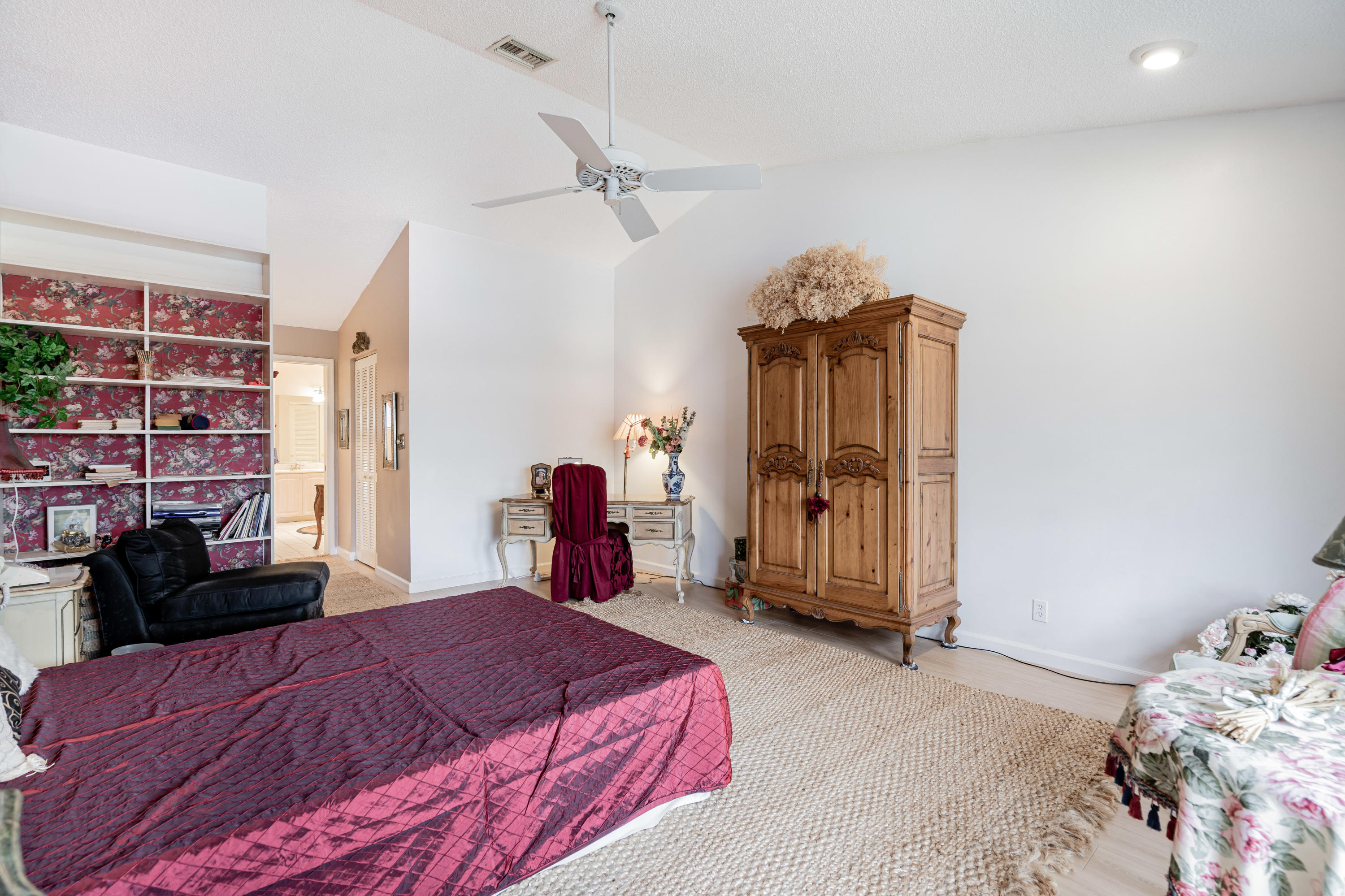 861 Camino Gardens Lane Boca Raton, FL 33432 - Photo 22 of 37 a bedroom with a bed and a walk in closet