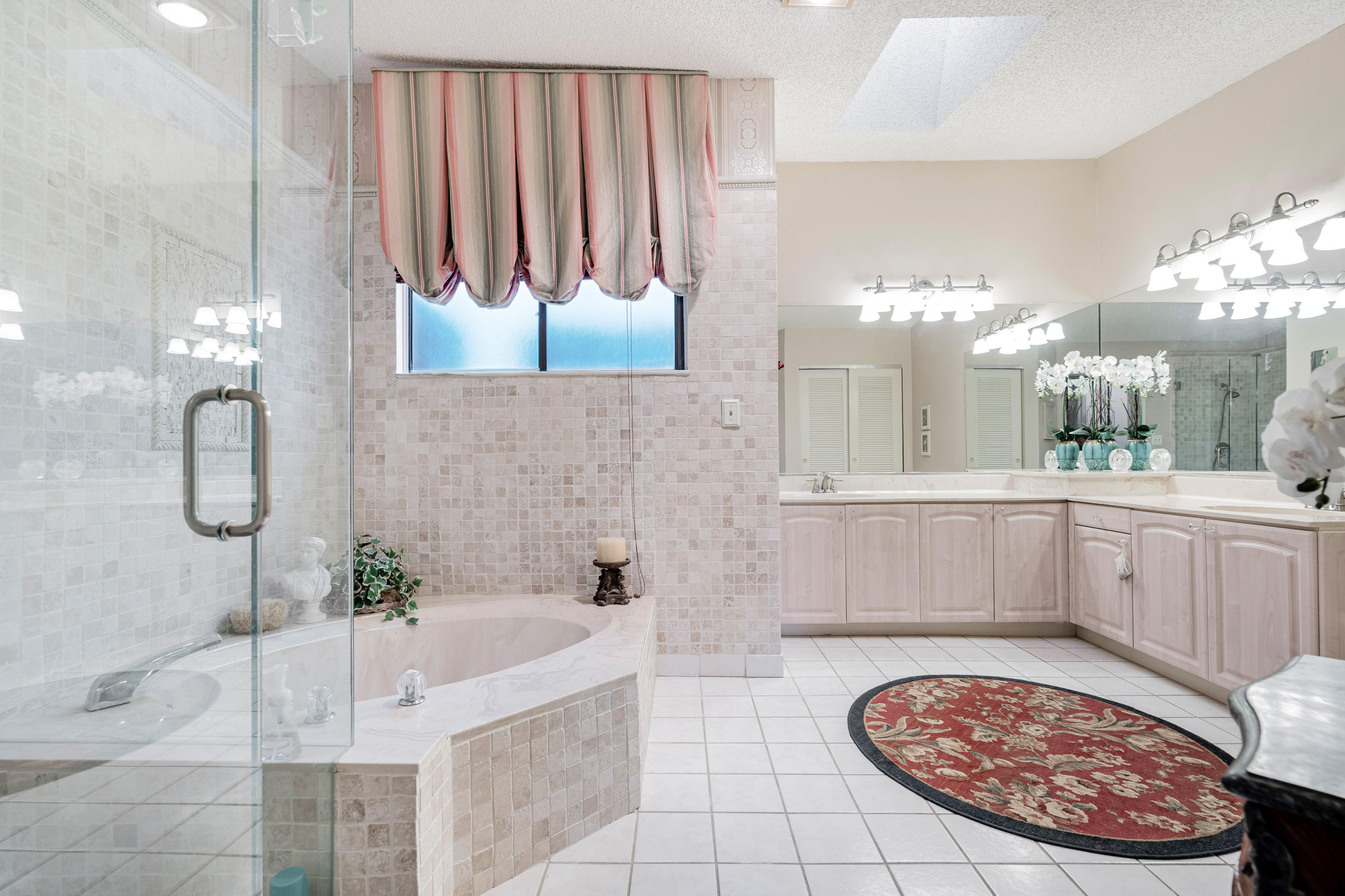 861 Camino Gardens Lane Boca Raton, FL 33432 - Photo 25 of 37 a bathroom with a tub a sink and a shower