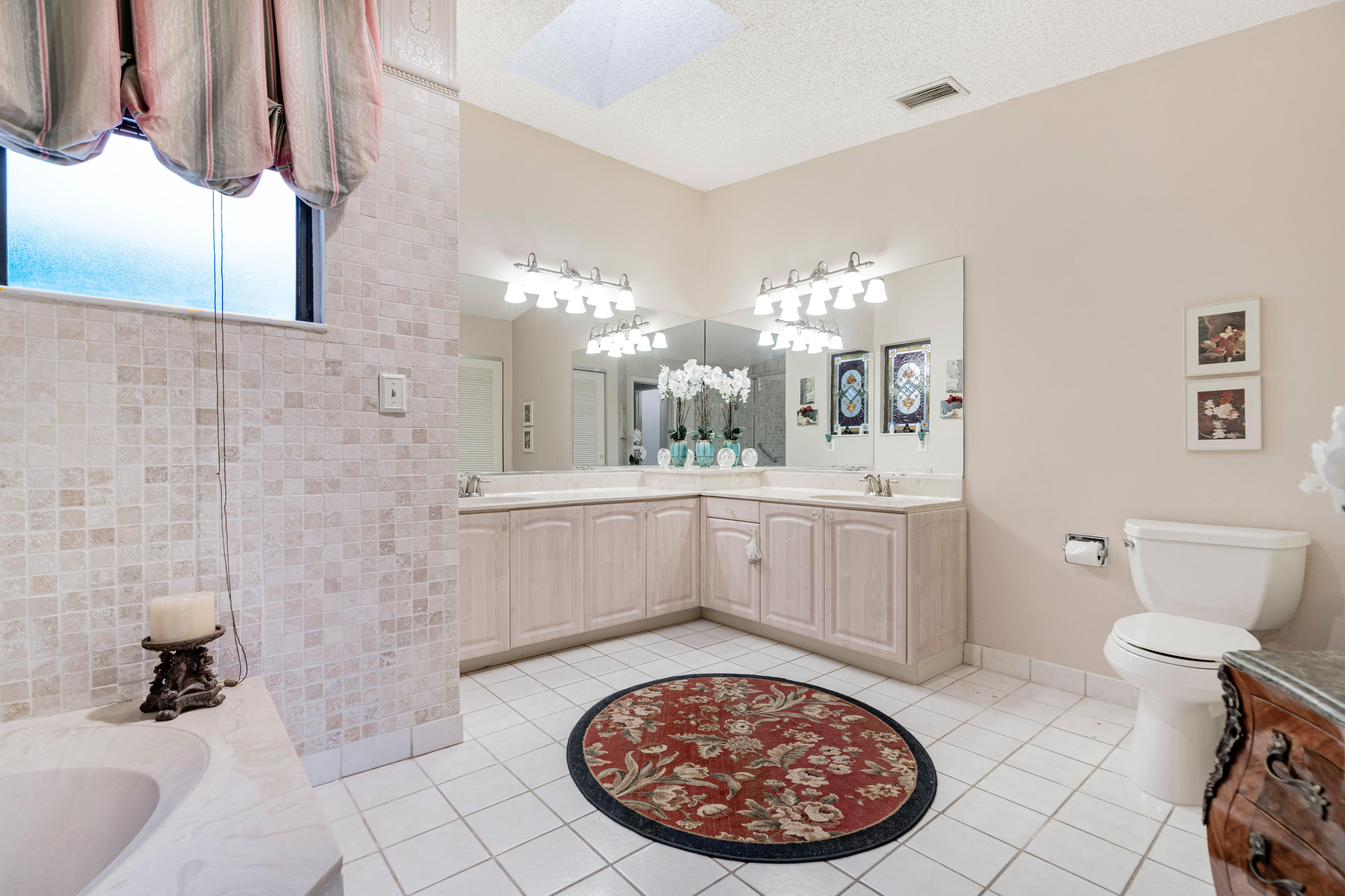 861 Camino Gardens Lane Boca Raton, FL 33432 - Photo 26 of 37 a bathroom with a sink a toilet and mirror