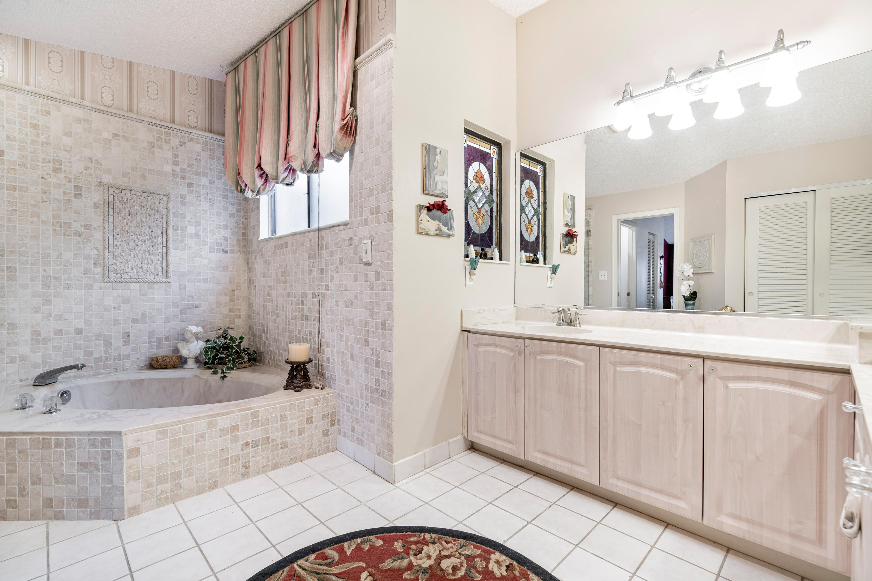 861 Camino Gardens Lane Boca Raton, FL 33432 - Photo 28 of 37 a bathroom with a bathtub and a sink