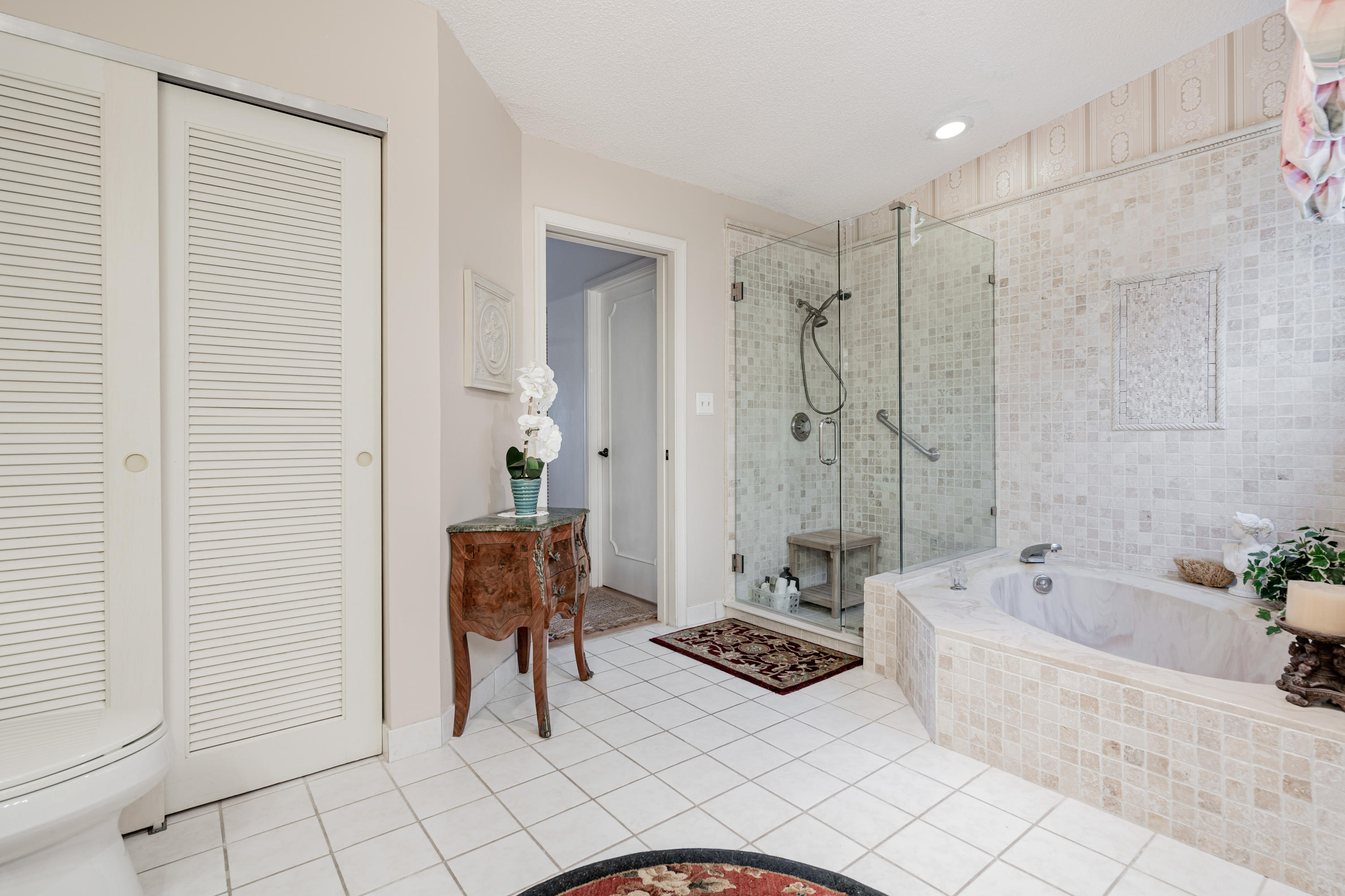 861 Camino Gardens Lane Boca Raton, FL 33432 - Photo 29 of 37 a bathroom with a tub shower and a sink