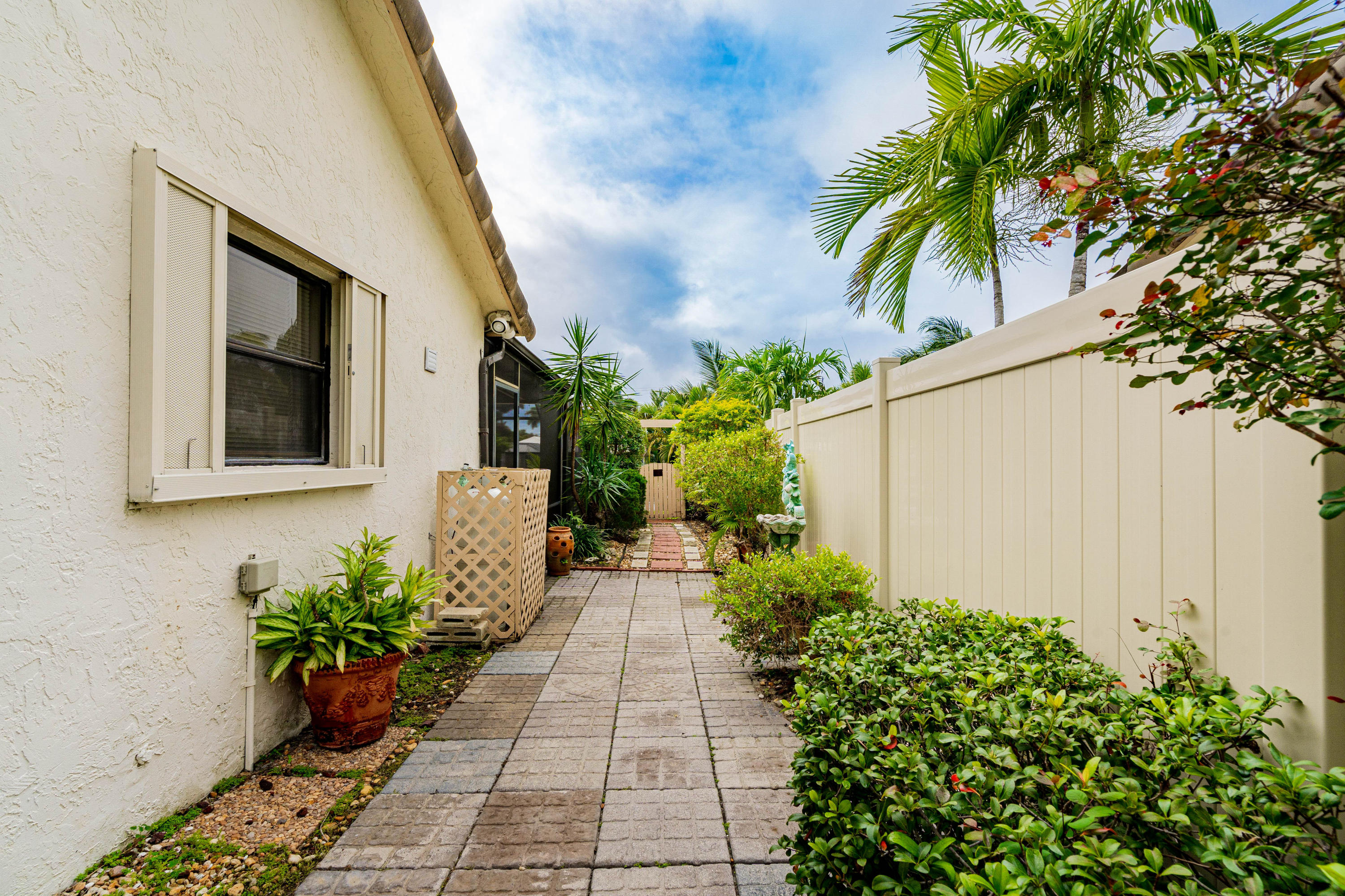 861 Camino Gardens Lane Boca Raton, FL 33432 - Photo 32 of 37 a view of a entryway with flower plants