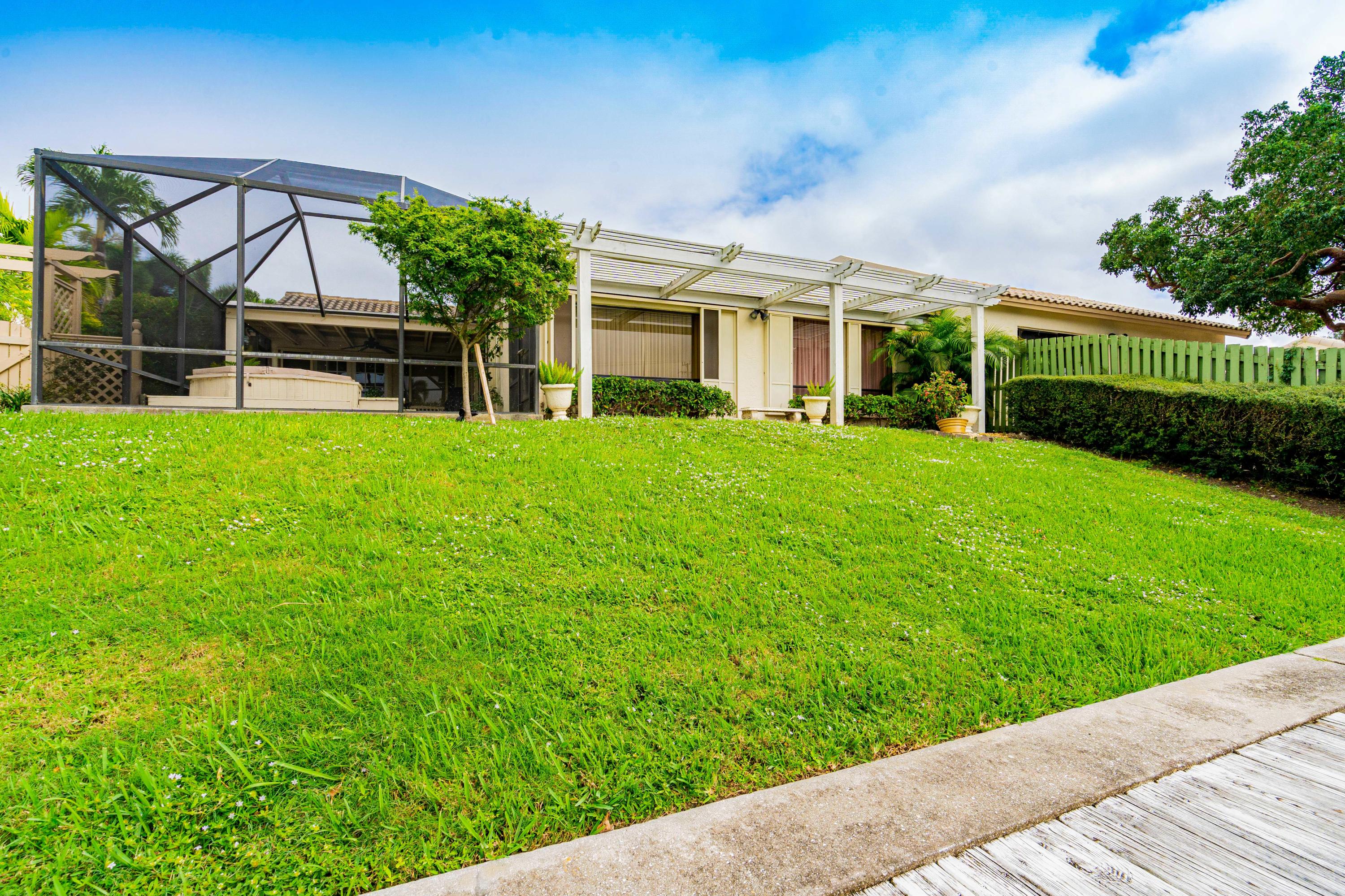861 Camino Gardens Lane Boca Raton, FL 33432 - Photo 34 of 37 a view of a house with backyard and a garden