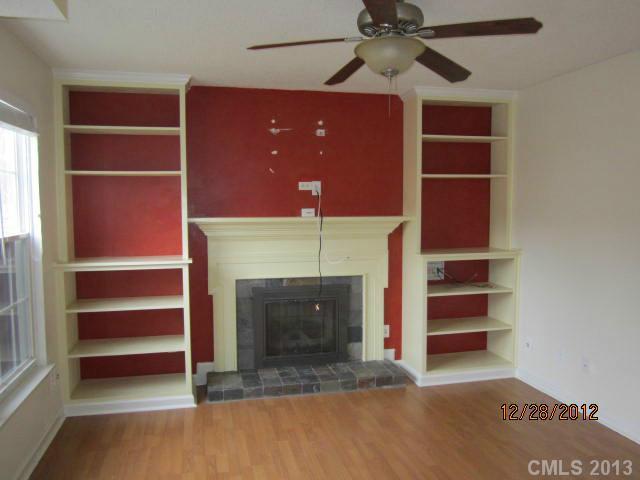 1901 Pine Mountain Road Charlotte, NC 28214 - Photo 3 of 10 a view of an empty room with a fireplace and a window