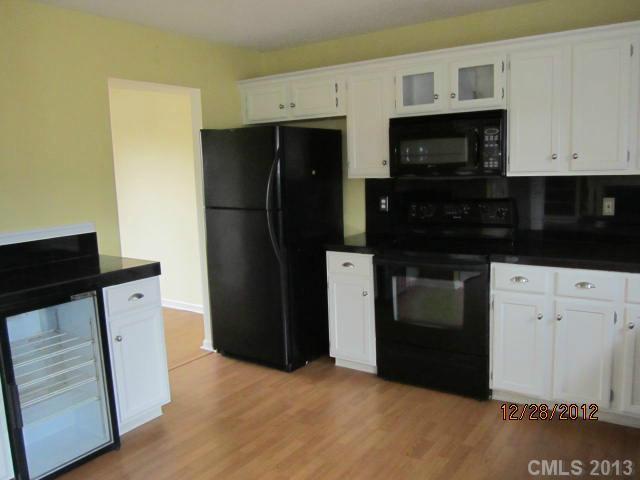 1901 Pine Mountain Road Charlotte, NC 28214 - Photo 5 of 10 a kitchen with a refrigerator and a stove top oven