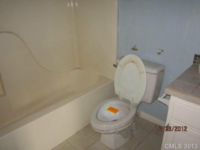 1901 Pine Mountain Road Charlotte, NC 28214 - Photo 10 of 10 a white toilet sitting next to a bath tub